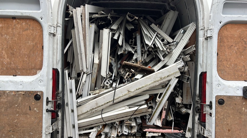 Bulk uPVC window frames stacked in a collection van