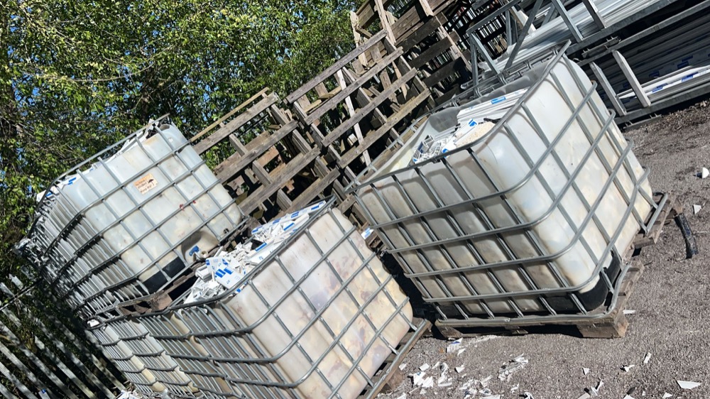 IBC bulk tubs of clean white uPVC profile offcuts at a fabricator's factory