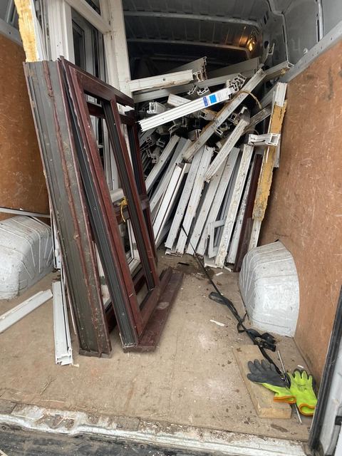 uPVC doors and coloured frames loaded in a collection van