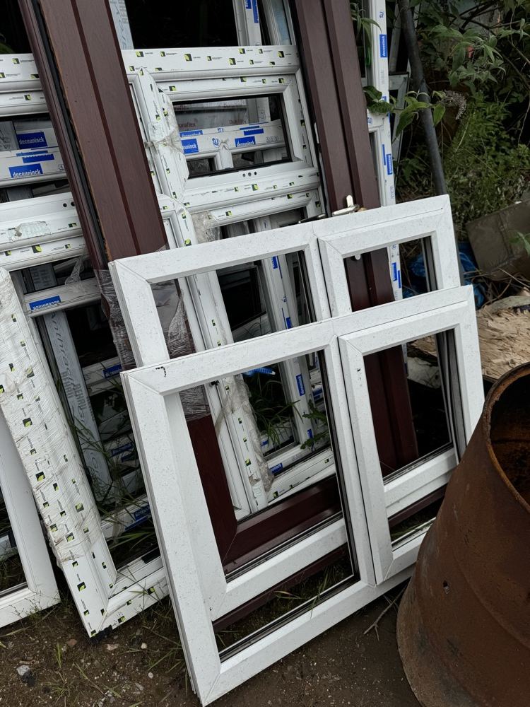 Stacked uPVC frames with manufacturer labels at our recycling yard