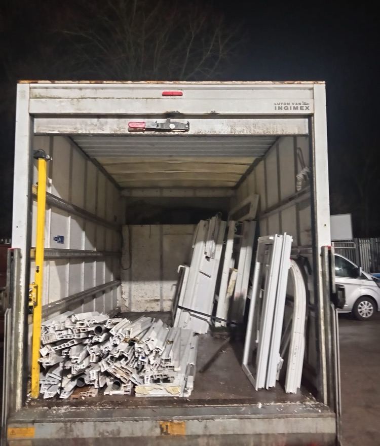 Scrap uPVC frames and offcuts loaded in the back of a Luton van