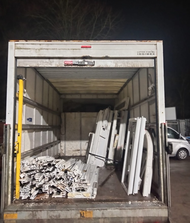 Luton van loaded with uPVC profile offcuts and frames — a typical trade collection load