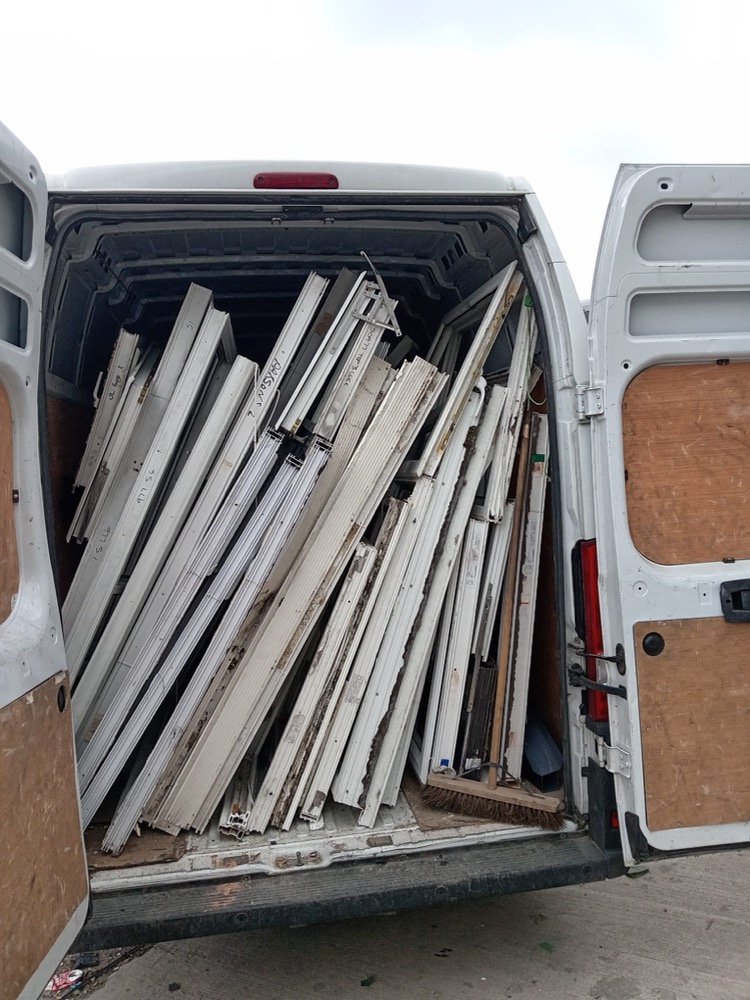 Wigan trade collection van loaded with stacked uPVC frame profiles from a Greater Manchester job